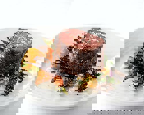 RCI Mariner of the Seas Main Diningmain-dining-room-sliced-steak-topped-with-sea-salt.jpeg