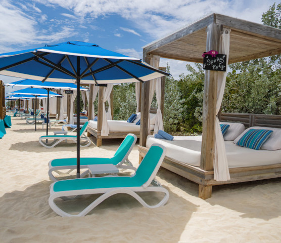 A row of Coco Beach Club sun loungers and cabanas at CocoCay.